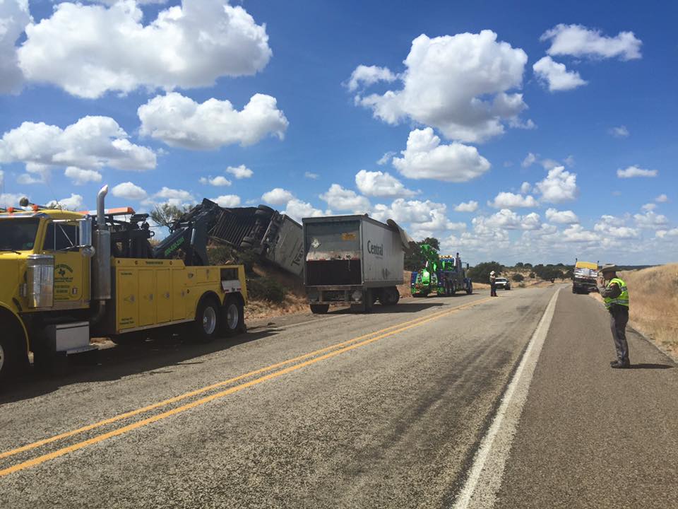 Welch Bros Towing wreckers clearing an overturned freight trailer accident on a Central Texas highway